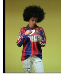 a woman with an afro is holding a cup