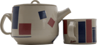 a teapot and mug with red, blue and white squares